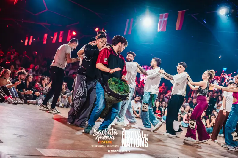 A drummer leading the dancers around the floor