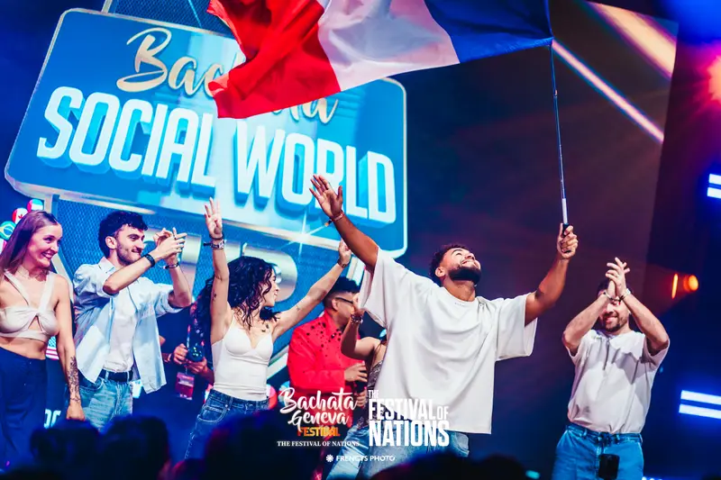 The French flag flying over dancers on stage