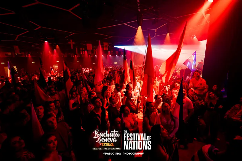 The hall lit in red with flags raised during the Parade of Nations